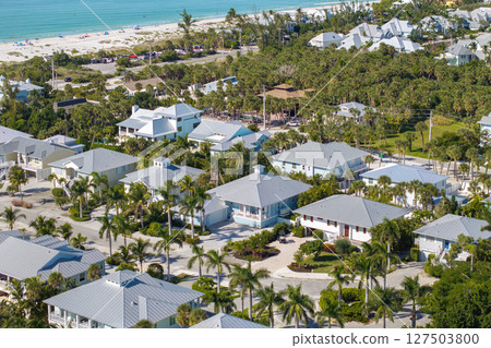 Expensive residential houses in island small town Boca Grande on Gasparilla Island in southwest Florida. American dream homes as example of real estate development in US suburbs Expensive residential houses in island small town Boca Grande on Gasparilla Island in southwest Florida. American dream homes as example of real estate development in US suburbs 127503800