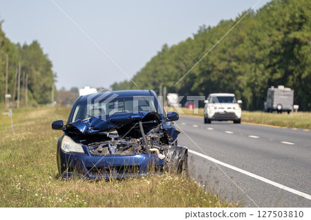 Dumped crashed car after traffic accident parked on highway roadside Dumped crashed car after traffic accident parked on highway roadside 127503810