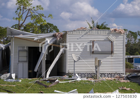 Destroyed by hurricane suburban houses in Florida mobile home residential area. Consequences of natural disaster 127503830