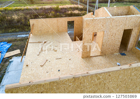 Construction of new and modern modular house. Walls made from composite wooden sip panels with styrofoam insulation inside. Building new frame of energy efficient home concept. 127503869
