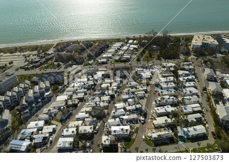 Consequences of natural disaster in southern Florida after hurricane season. Severely damaged houses in mobile home residential area Consequences of natural disaster in southern Florida after hurricane season. Severely damaged houses in mobile home residential area 127503873