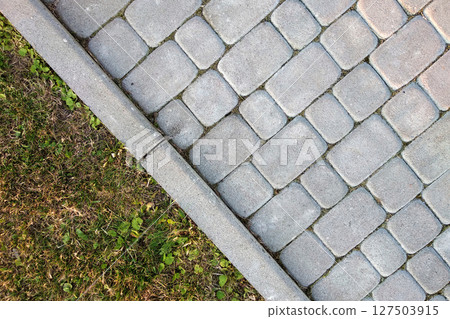 Close-up of slab stone paved path way at park or backyard. Walkway footpath road at house yard garden. Close-up of slab stone paved path way at park or backyard. Walkway footpath road at house yard garden. 127503915