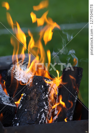 Burning fire in the brazier. 127504078