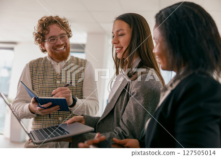 Participating in a Collaborative Team Meeting within a Modern Office Environment and Setting Participating in a Collaborative Team Meeting within a Modern Office Environment and Setting 127505014