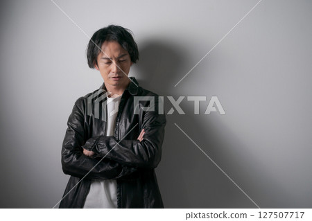 Portrait of a man wearing a leather jacket Portrait of a man wearing a leather jacket 127507717