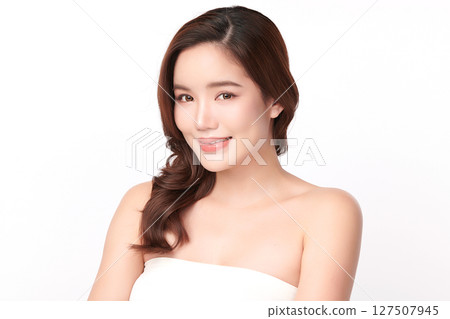 A beautiful young Asian woman with clean, fresh skin against a white background. Skincare, facial treatment, cosmetology, beauty, and spa. An elegant portrait of an Asian woman. 127507945