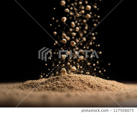 Brown Granules Falling on Heap, Black Background 127508873