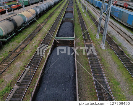 numerous coal wagons line railway tracks efficient transportation infrastructure in industrial area. numerous coal wagons line railway tracks efficient transportation infrastructure in industrial area. 127509490