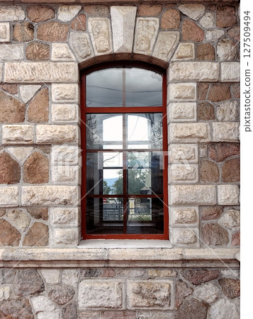 marble wall with red framed window showcasing scenic outdoor view during clear day. closeup. marble wall with red framed window showcasing scenic outdoor view during clear day. closeup. 127509494