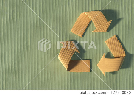 3D render of a recycle symbol made from corrugated cardboard on a green textured background 127510080