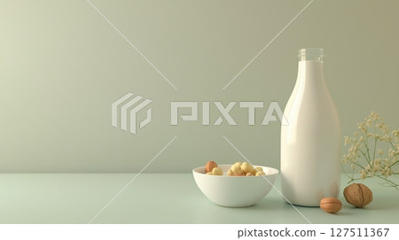 Hazelnut on bottle milk and hazelnuts on bowl copy space background 127511367
