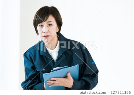 Middle-aged woman in work clothes Middle-aged woman in work clothes 127511396