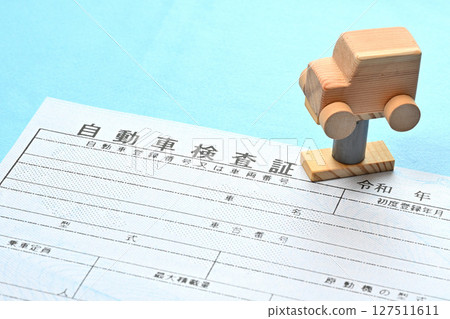 Image of an electronic vehicle inspection certificate and a car on a lift Image of an electronic vehicle inspection certificate and a car on a lift 127511611