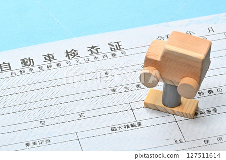 Image of an electronic vehicle inspection certificate and a car on a lift Image of an electronic vehicle inspection certificate and a car on a lift 127511614
