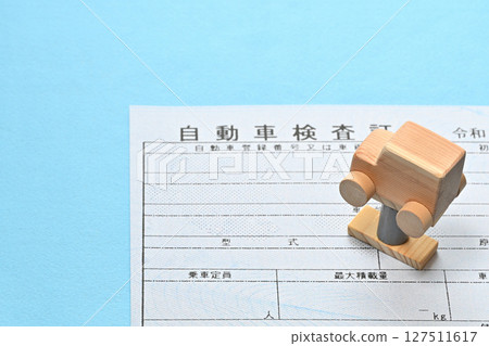 Image of an electronic vehicle inspection certificate and a car on a lift Image of an electronic vehicle inspection certificate and a car on a lift 127511617