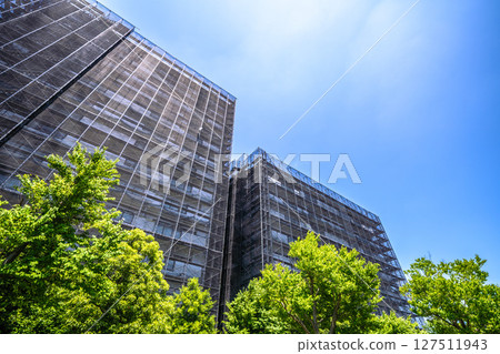 Yokohama cityscape in Japan. Apartment building repairs and inspections, scaffolding and protective nets. Satellite antennas outside the nets... Yokohama cityscape in Japan. Apartment building repairs and inspections, scaffolding and protective nets. Satellite antennas outside the nets... 127511943