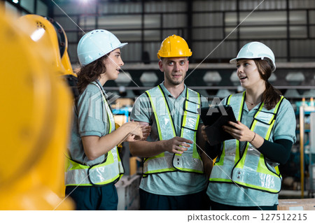 Robotic engineer team automatic mechanic checking quality system of automation robot arms machine in factory. Service programming machinery welding robots in production at factory industry. Robotic engineer team automatic mechanic checking quality system of automation robot arms machine in factory. Service programming machinery welding robots in production at factory industry. 127512215
