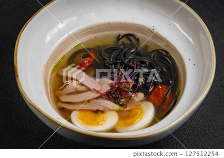 chicken noodle soup. curry soup close-up Japanese food Chinese dish. chicken soup with turkey and black spaghetti. chicken noodle soup. curry soup close-up Japanese food Chinese dish. chicken soup with turkey and black spaghetti. 127512254