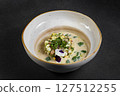 Cold summer soup okroshka. Light soup in a white bowl.  127512255