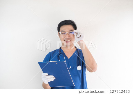Asian Male Nurse Wearing Glasses and Holding Clipboard Asian Male Nurse Wearing Glasses and Holding Clipboard 127512433