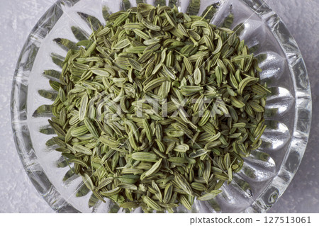 fragment of glass bowl with fennel seeds top view 127513061