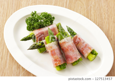 Bacon wrapped asparagus served on a plate 127513457