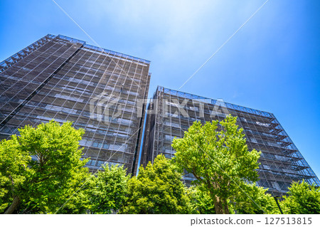 Yokohama cityscape in Japan. Apartment building repairs and inspections, scaffolding and protective nets. Satellite antennas outside the nets... Yokohama cityscape in Japan. Apartment building repairs and inspections, scaffolding and protective nets. Satellite antennas outside the nets... 127513815