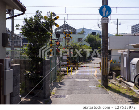 Scene of an alleyway with a railroad crossing alarm going off 127515972