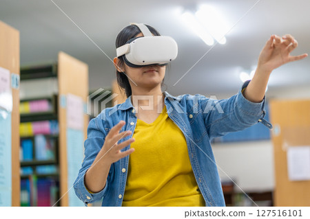Young Woman Exploring Virtual Reality in Library 127516101