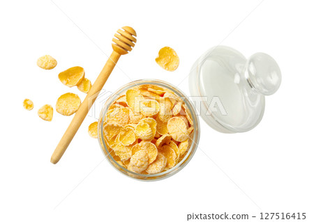 Corn flakes and honey displayed in a jar, isolated on white 127516415