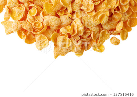 Golden corn flakes on a smooth surface, isolated on white 127516416