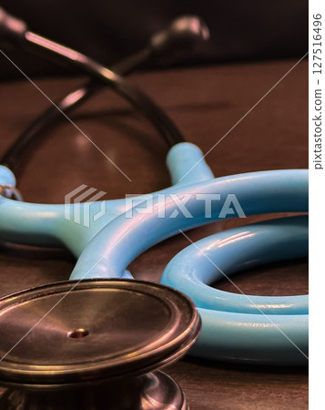Blue Stethoscope Close-up on Medical Desk 127516496