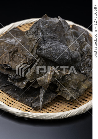 黑色背景下，用竹篩盛裝的羅臼海帶 127516697