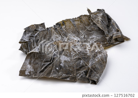 Cut pieces of Rausu kelp placed on a white background Cut pieces of Rausu kelp placed on a white background 127516702