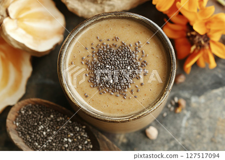 Homemade smoothie with chia seeds in a glass, top view. Healthy and tasty food concept. Homemade smoothie with chia seeds in a glass, top view. Healthy and tasty food concept. 127517094