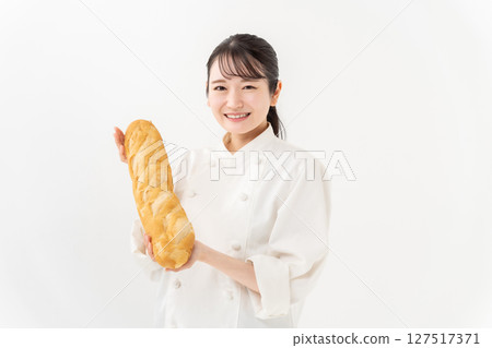 Woman in chef's coat with bucket 127517371