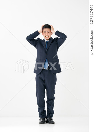 Young male business whole body holding head Young male business whole body holding head 127517445