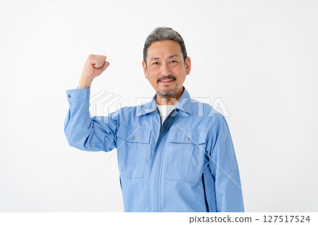 Man in work clothes, fist pump Man in work clothes, fist pump 127517524
