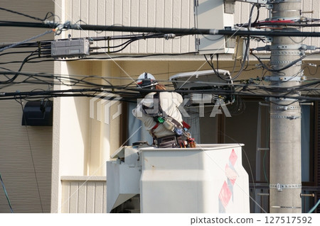 A person who does wiring work at a height 127517592
