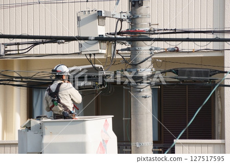 Man doing electrical work on a lift vehicle 127517595