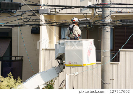 A man working at height using a lift truck A man working at height using a lift truck 127517602