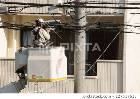 A person who installs optical fiber wiring A person who installs optical fiber wiring 127517613