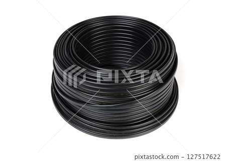 Black plastic cable coil, ideal for electrical or industrial use, isolated on a white background. 127517622