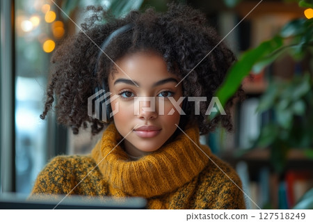 a modern tutor hosting an online class, wearing headphones and speaking into a microphone, stylish home office with books 127518249