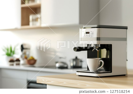 Modern black coffee machine brewing espresso into a white cup in a cozy home kitchen with warm morning light.  127518254