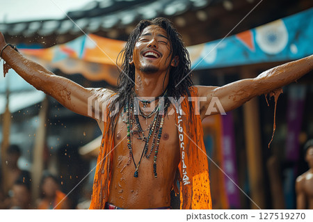 a performer at Boryeong Mud Festival, entertaining a crowd with a mud themed costume and energetic dance 127519270