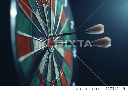 Two darts hitting the bullseye on a dartboard during a competitive match at night 127519449