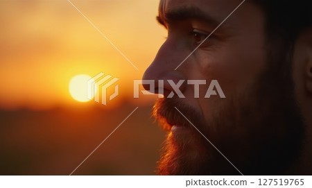 Golden sunset reflection on contemplative man 127519765