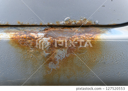 Close-up of rusty car sill with corrosion damage. 127520553