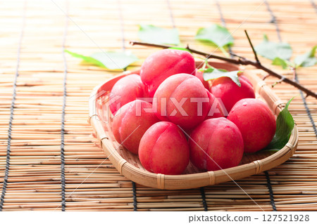 Early plums arranged in a basket 127521928